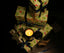 wrapped Christmas gifts with a ZENZAR candle on a dark background