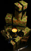 Stack of wrapped Christmas gifts with a ZENZAR candle on a dark background
