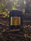 Zenzar ood wood  candle in a forest setting